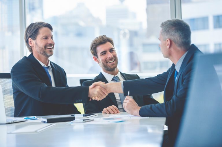 Business owners discussing a business acquisition financing transaction