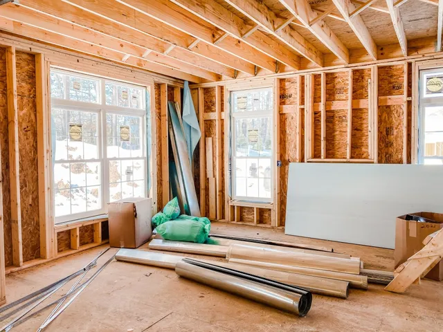 Unfinished remodeling interior with exposed framing and building materials