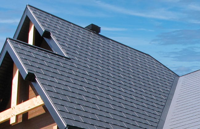 Close view of roof slopes and dark roofing materials